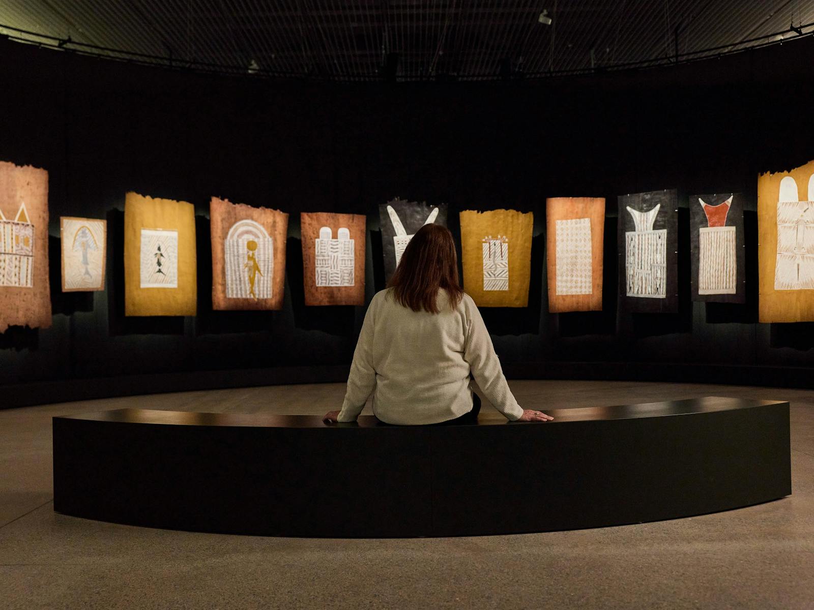 A person looking at a display of art