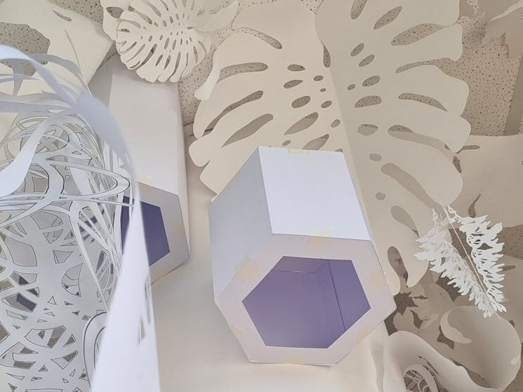 white paper cut into organic shapes in installation