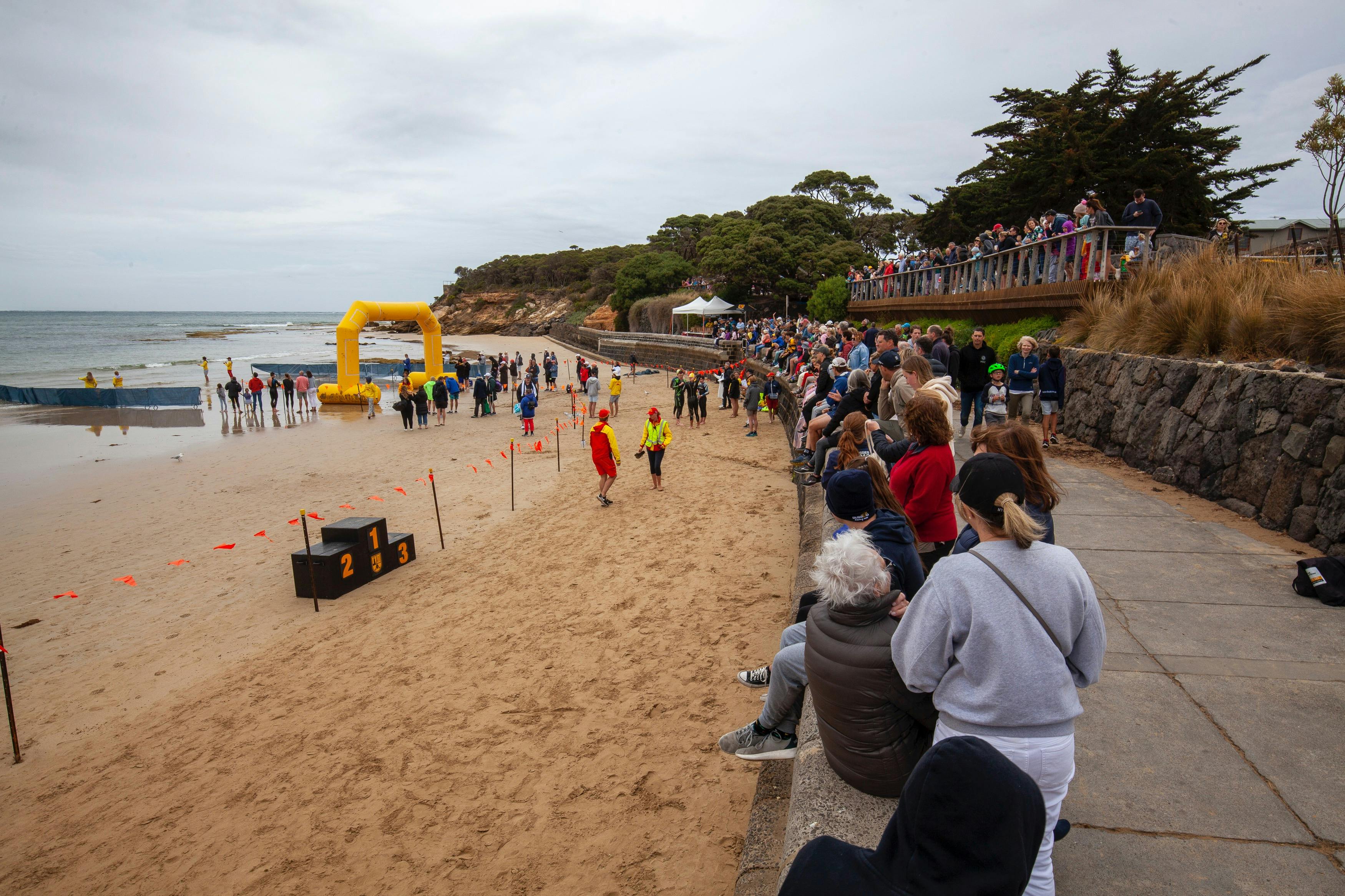 A shot of a beach with a finish line arch