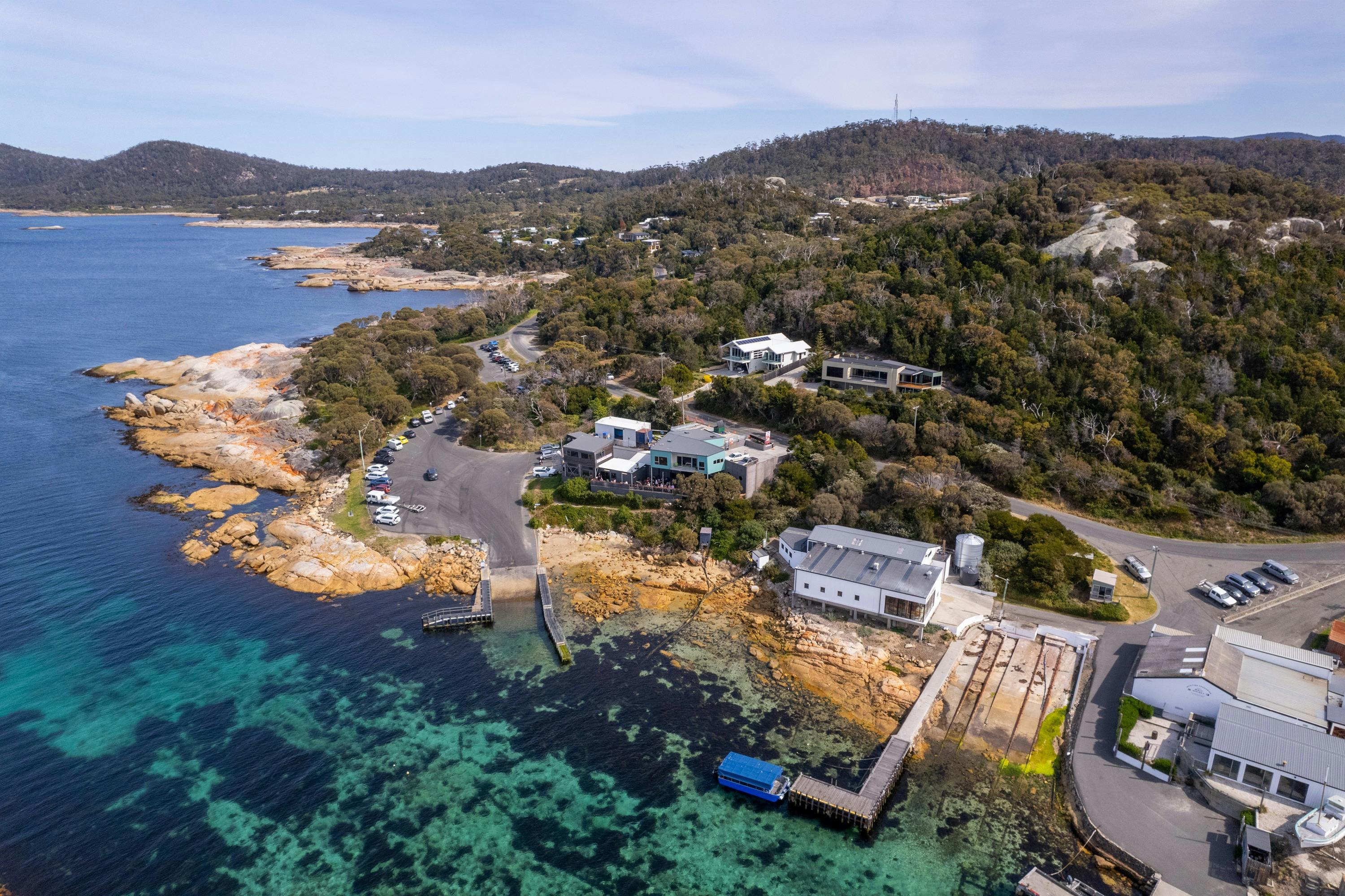 Aerial shot of Lobster Shack Tasmania situated on Bicheno's Gulch - a natural boat harbour