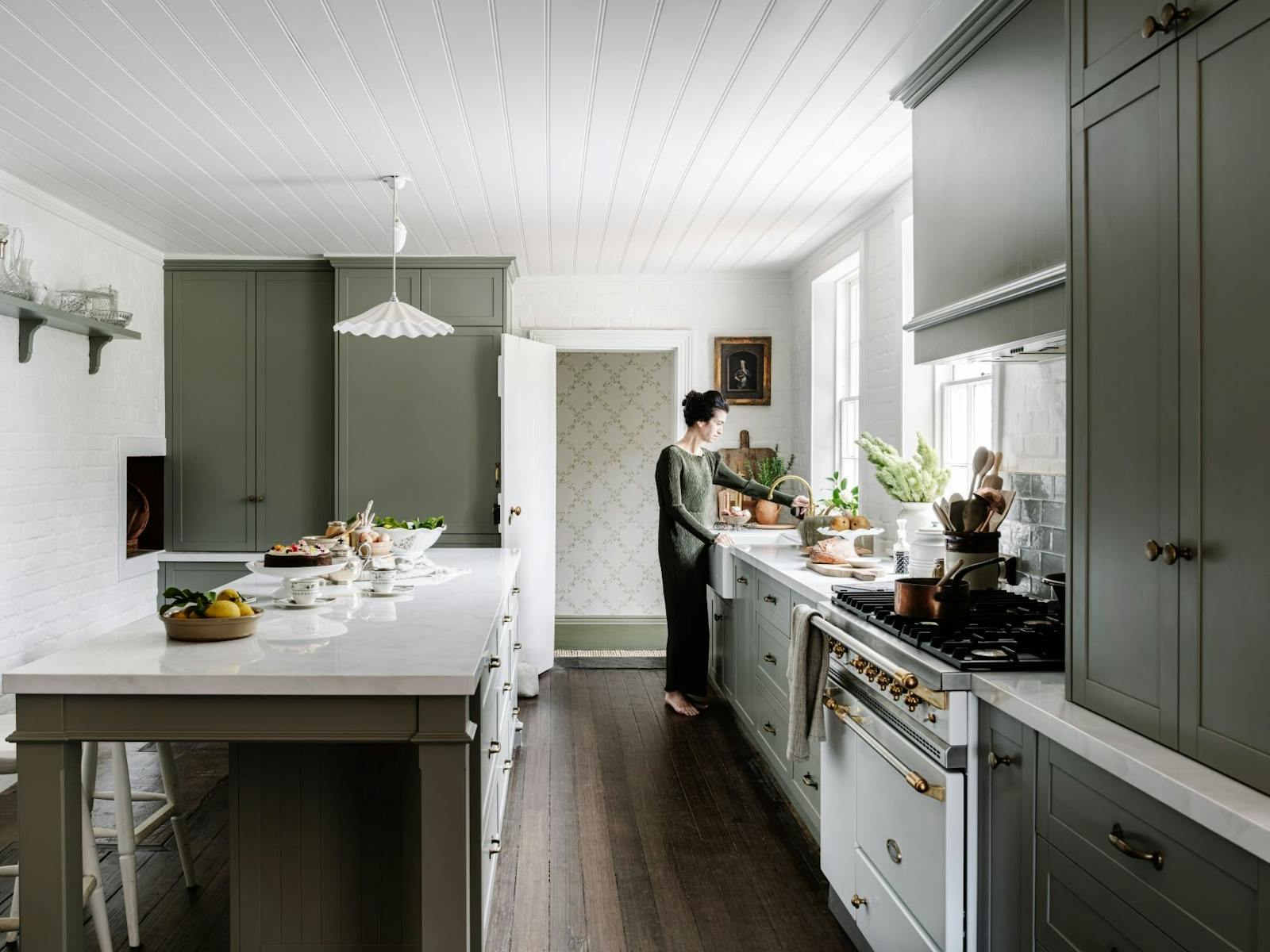 A tastefully renovated kitchehn with luxury appliances and large bar.