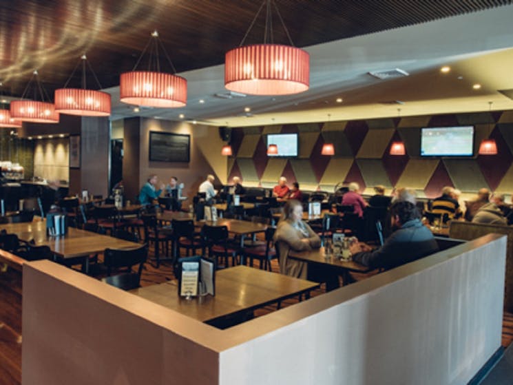 Customers eating in dining area at Camden Hotel