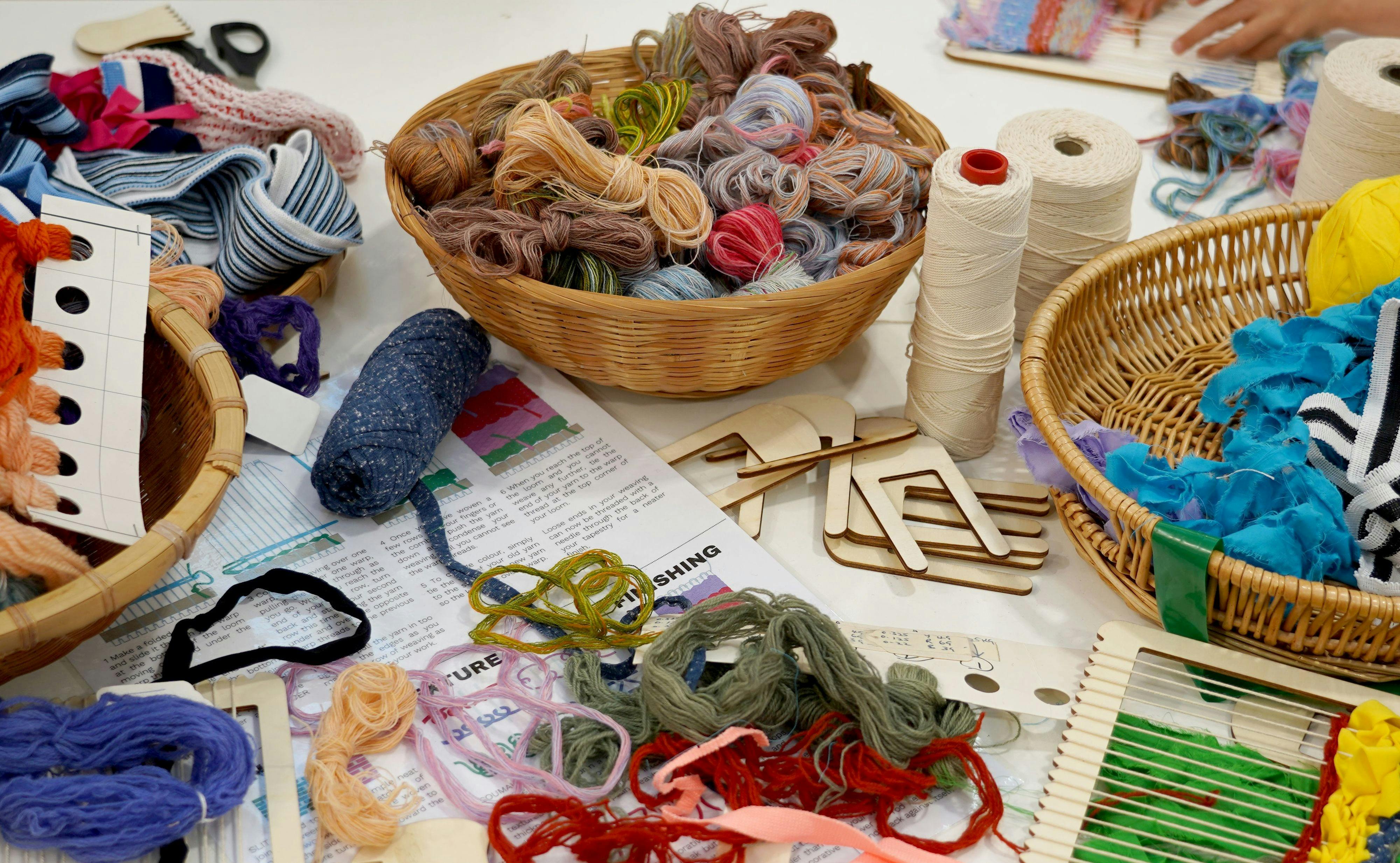 A table covered in weaving equipment and yarn