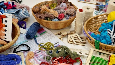 A table covered in weaving equipment and yarn