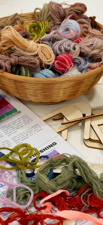 A table covered in weaving equipment and yarn