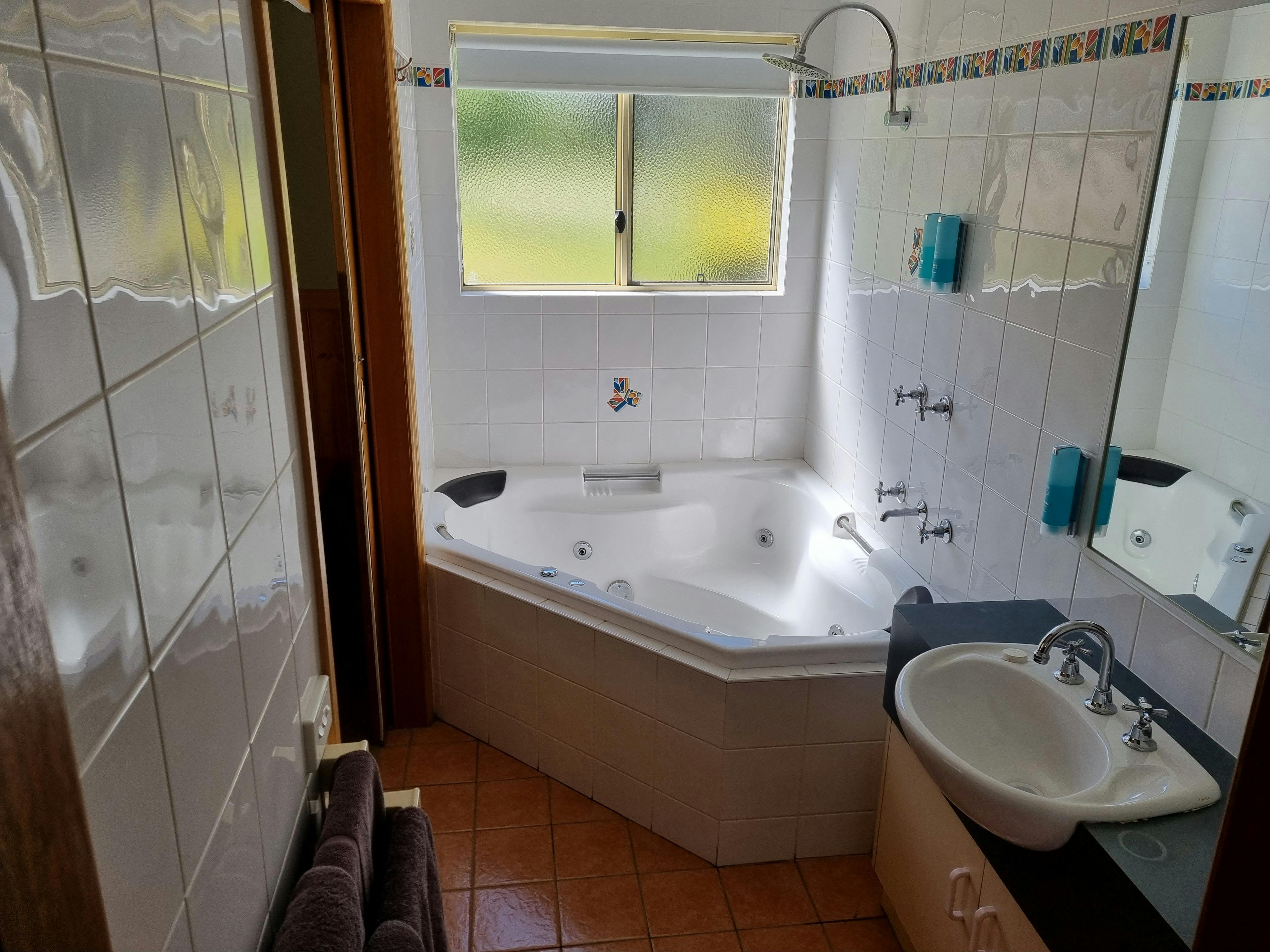 Spa Bathroom with shower over spa