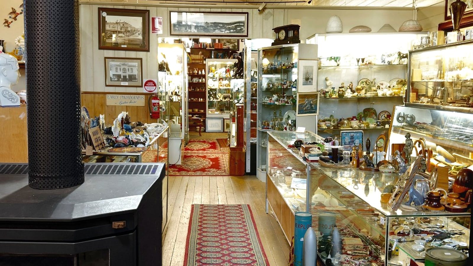 Cosy front gallery with wood heater, Tasmanian timber furniture and vintage collectables