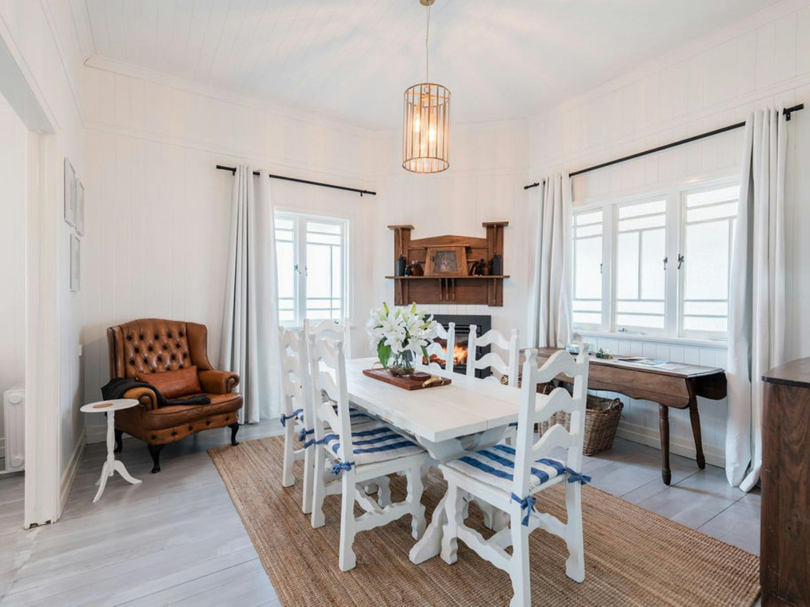 Dining Table with chairs for 6-10 and indoor fireplace and vintage leather club chair