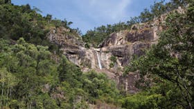 Jourama Falls, cliff face and surrounding forest.