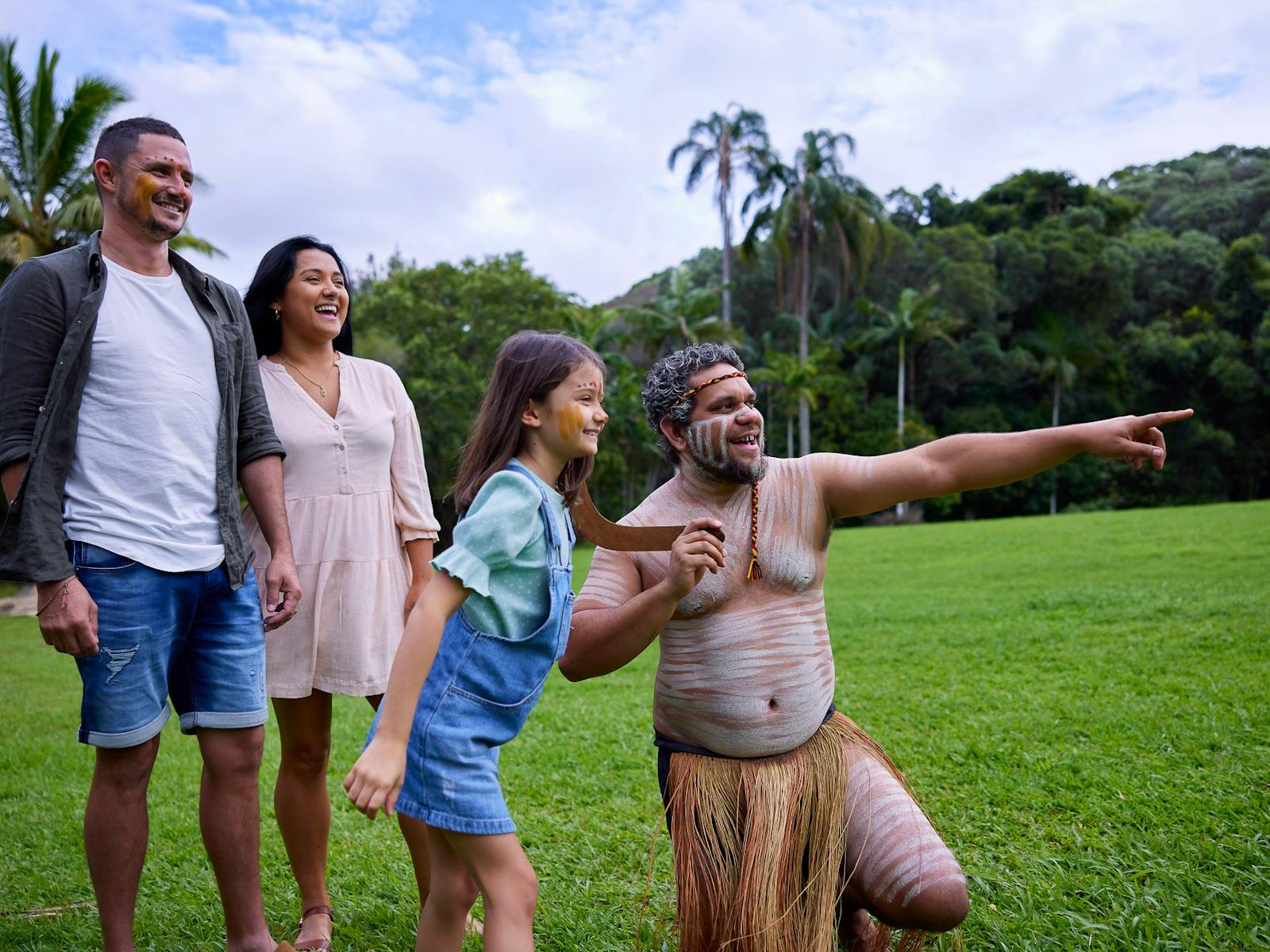 Pamagirri Aboriginal guide showing a family of three how to throw boomerang at Rainforestation