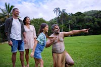 Pamagirri Aboriginal guide showing a family of three how to throw boomerang at Rainforestation