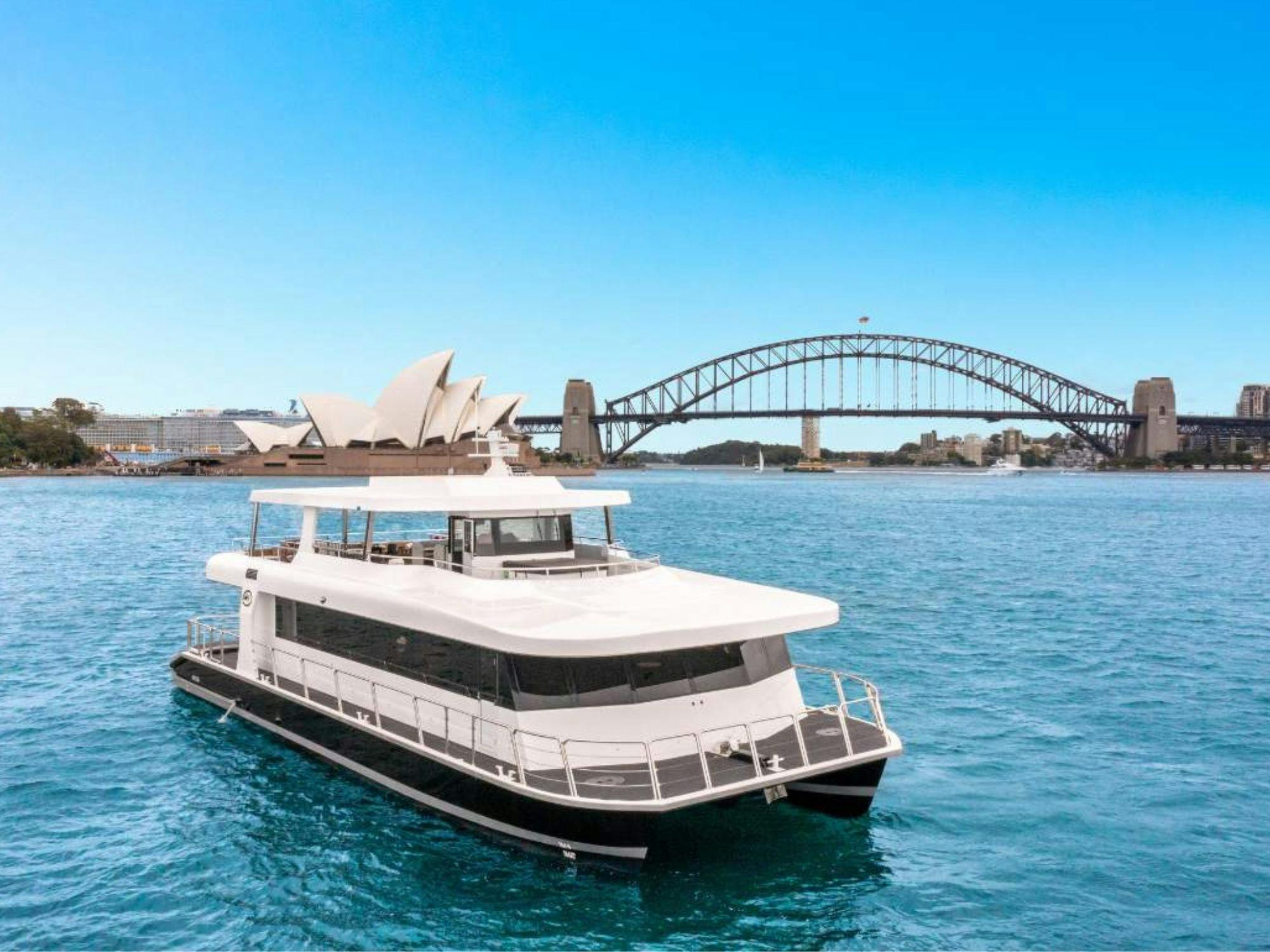 Karisma 2 cruising on Sydney Harbour with the Opera House and Harbour Bridge in the background