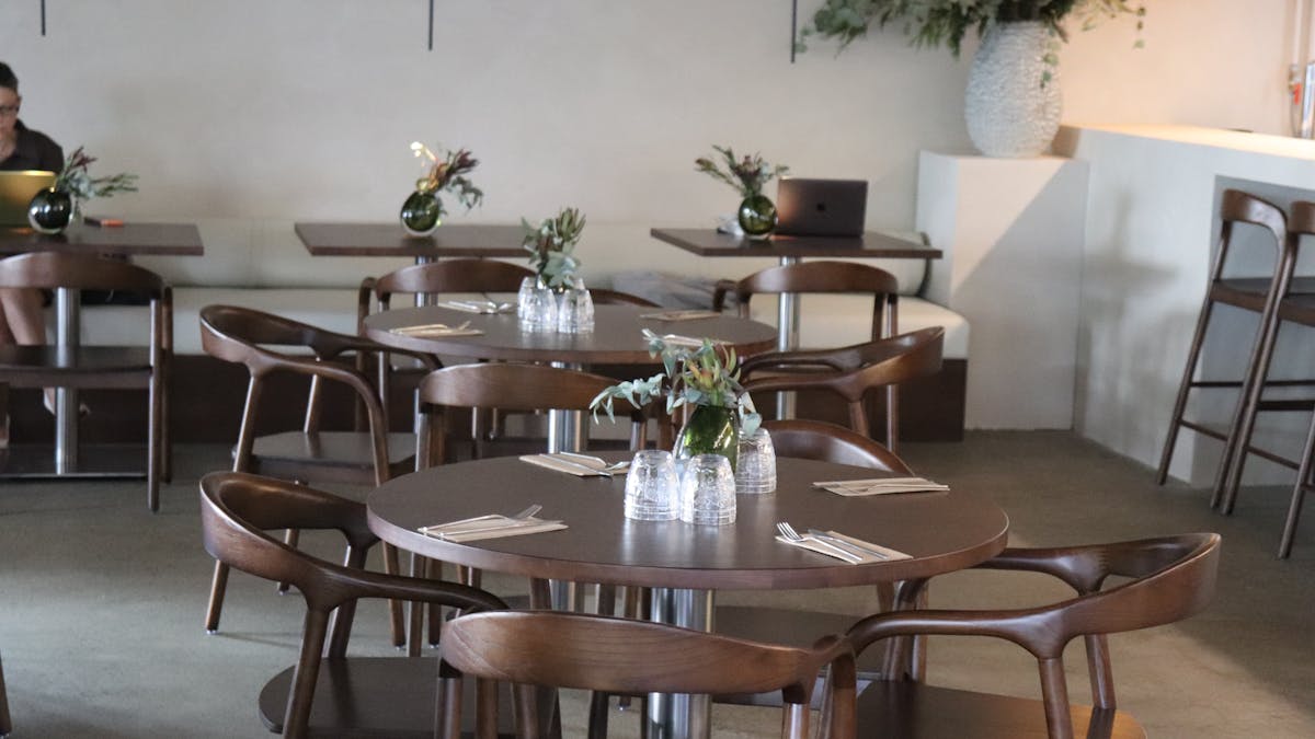The Pantry's new indoor dining chairs and tables. Chocolate brown, wooden, concrete floors.
