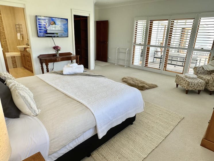 Huge Primary bedroom with King sized bed, ensuite with bath and WIR, all flowing out to the deck