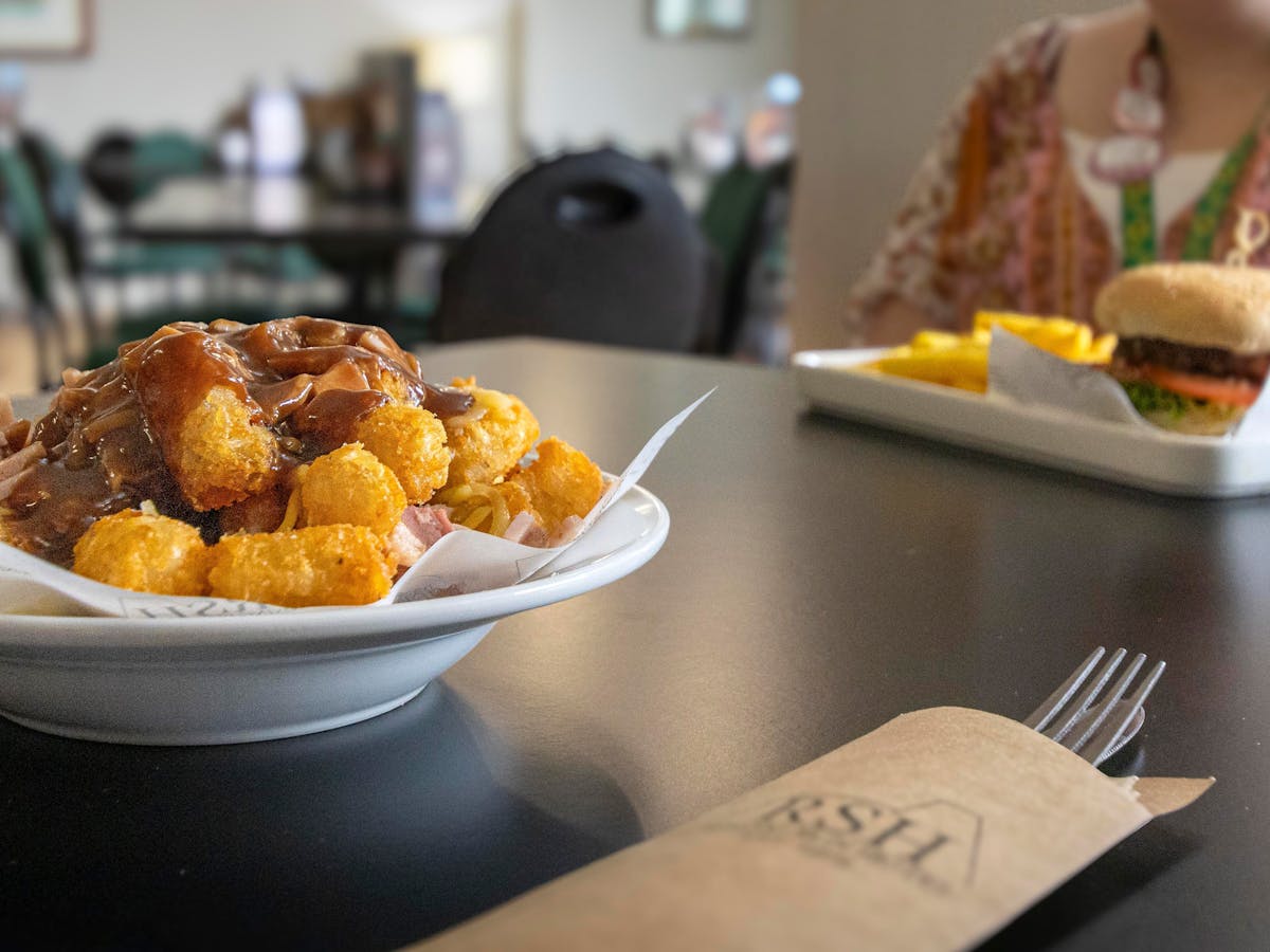 Loaded potato gems and a burger on a table.