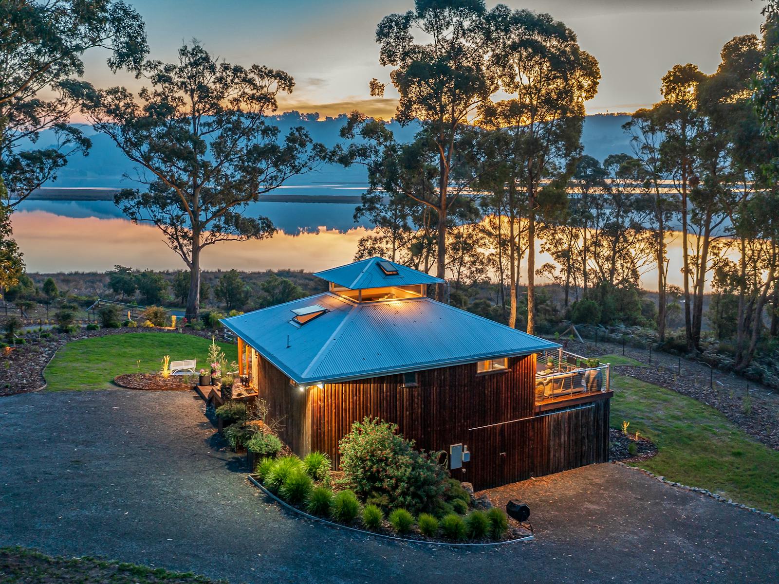 A drone shot of the Huon River Hideaway at golden hour
