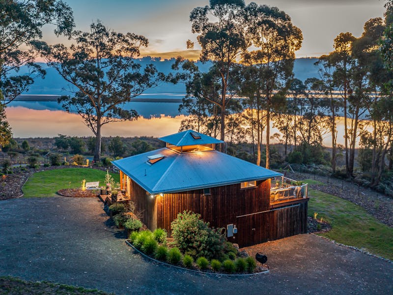 A drone shot of the Huon River Hideaway at golden hour