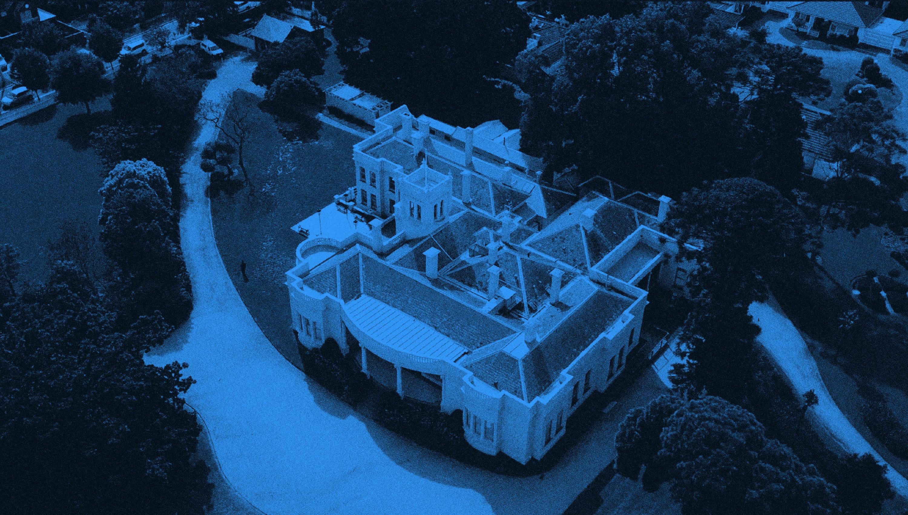 Arial photograph of Billilla Mansion, a large historic house. The photograph is tinted blue.