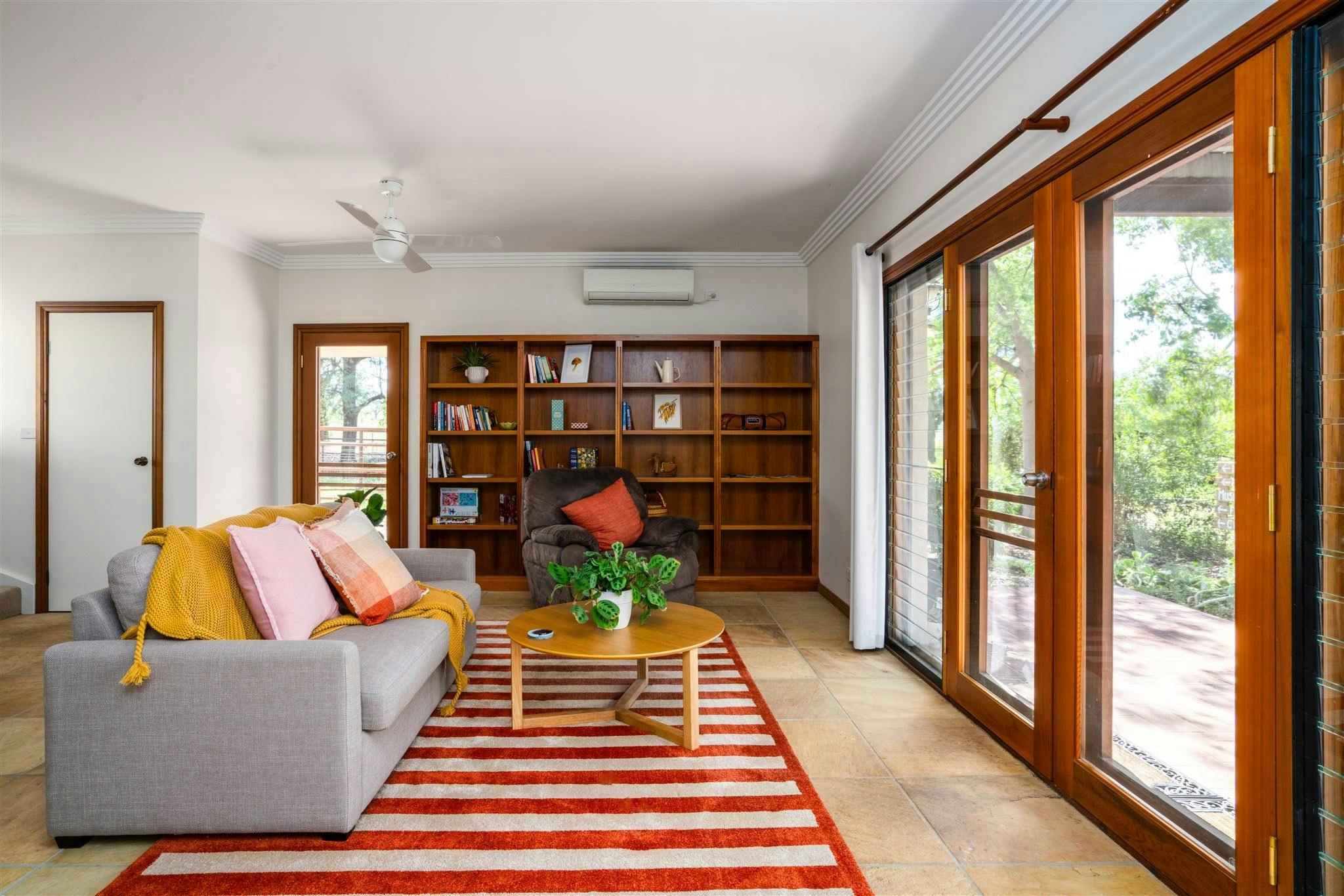 Lounge area, bookshelf, garden view