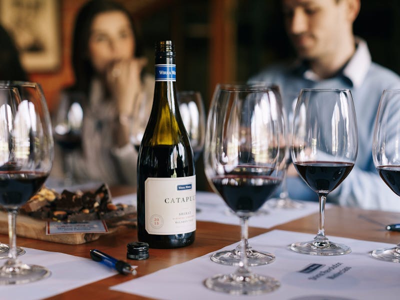 Glasses are laid out for a wine tasting with tasting mats.