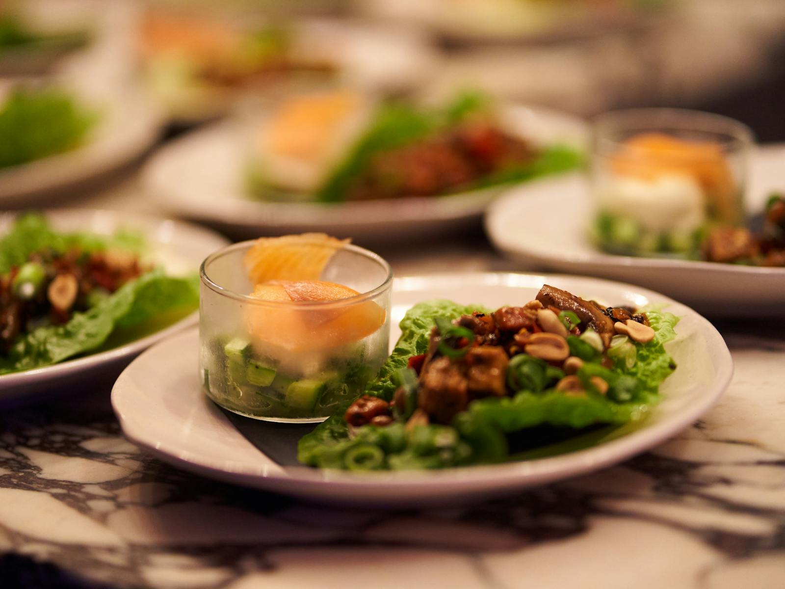 Entrees or salmon and fresh produce lined up ready to be served.