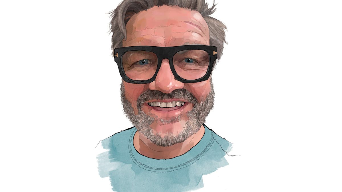 head shot of Lawrence with black rim glasses and light blue tshirt