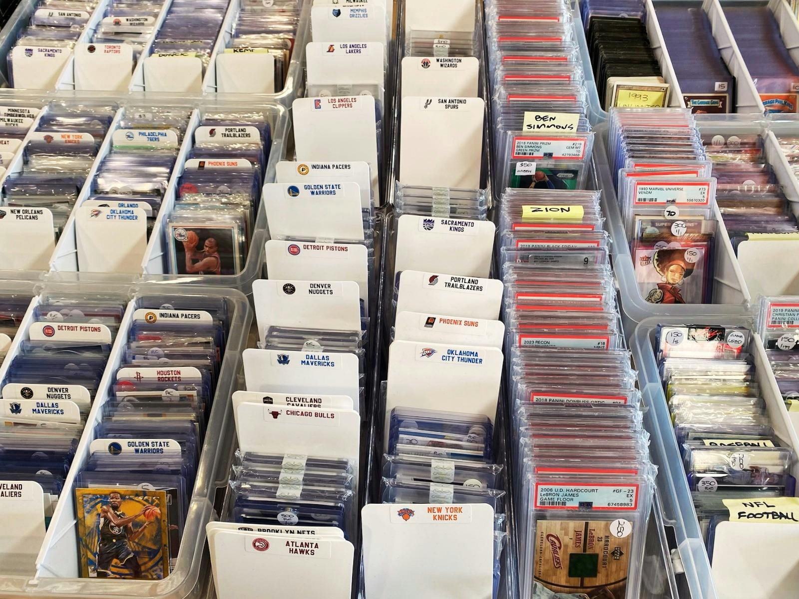 Boxes of singles trading cards displayed for attendees to sort through