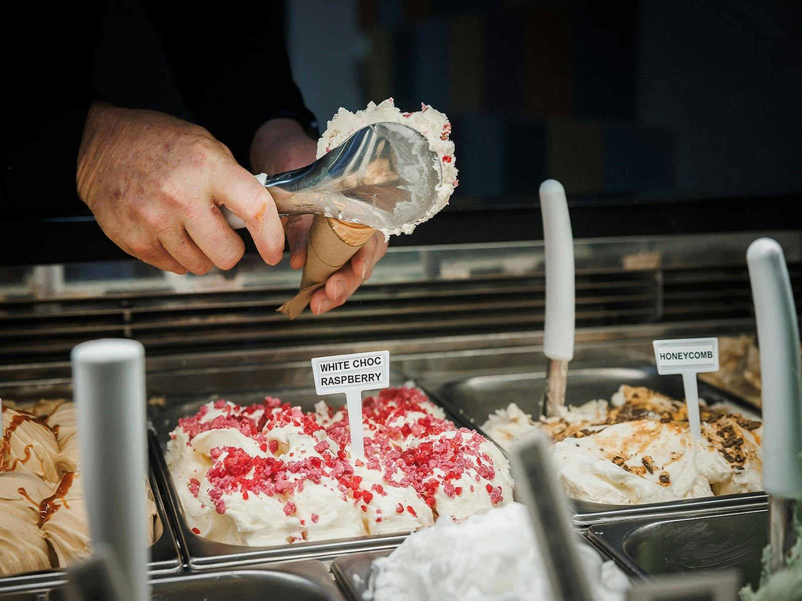 Scooping Artisan gelato into waffle cone