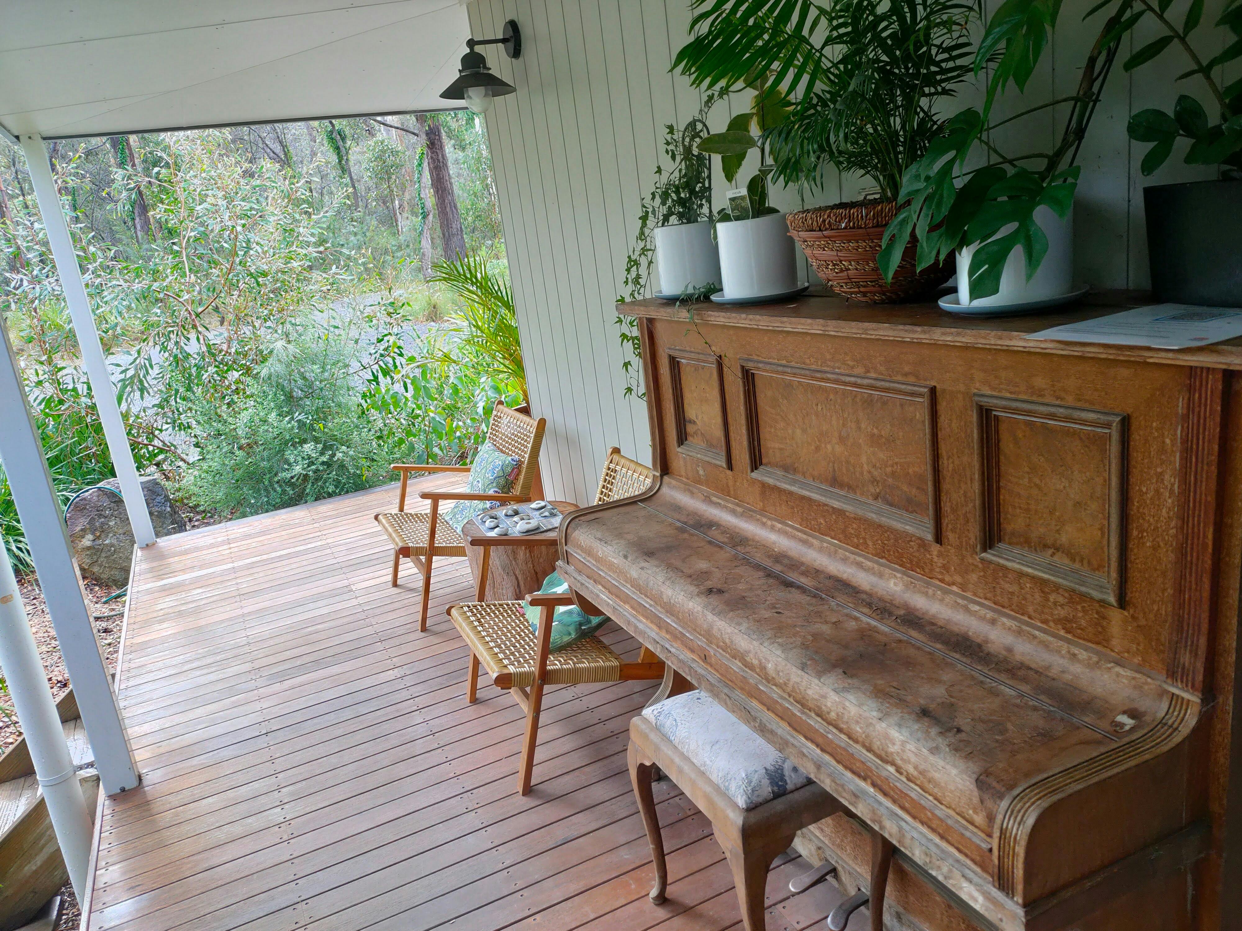 Piano and chairs on verandah