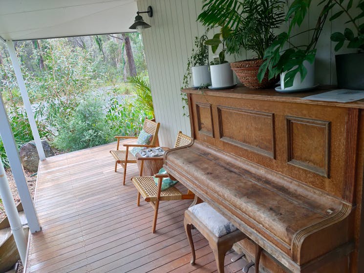 Piano and chairs on verandah