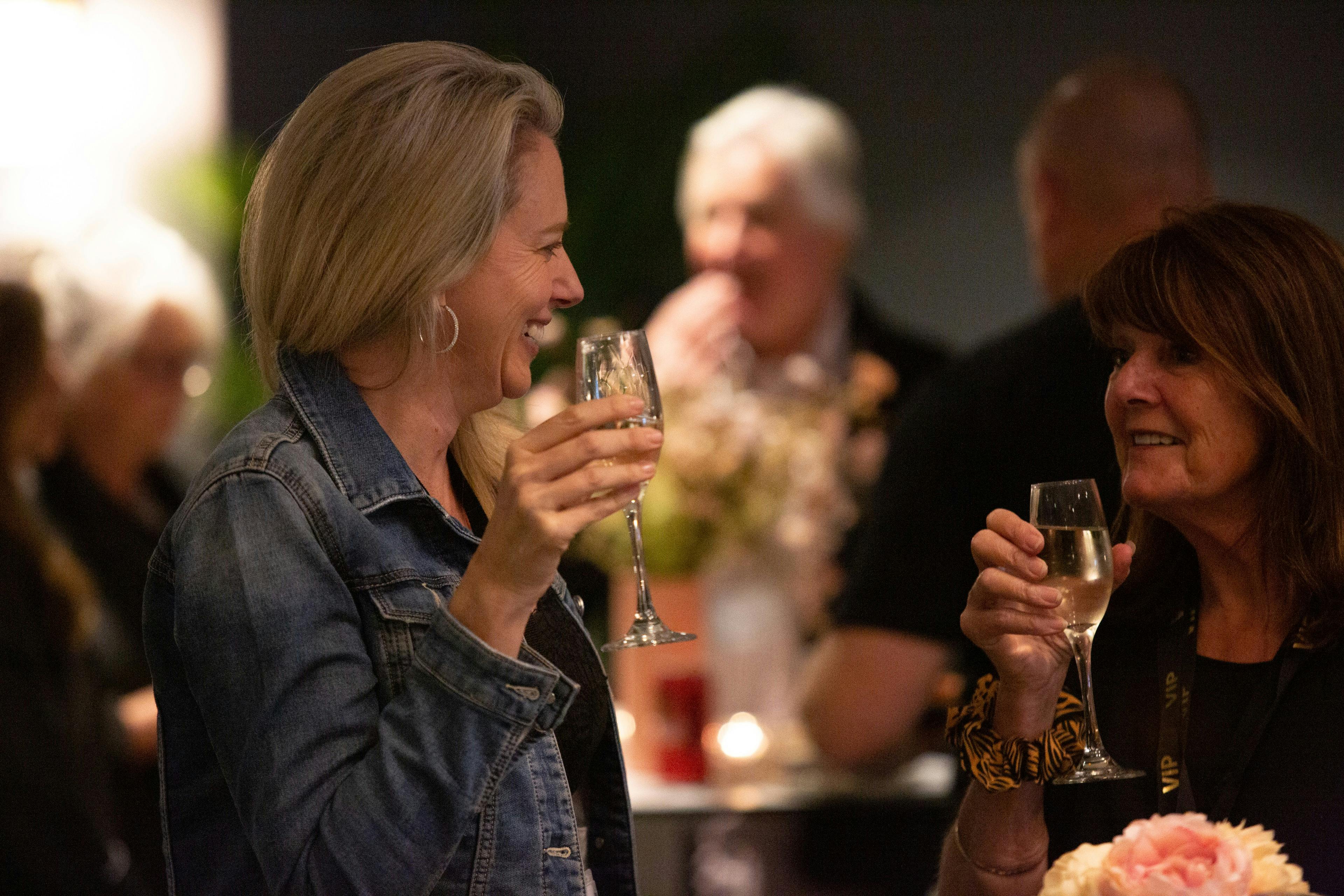 two guests enjoying a glass of bubbles