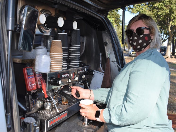Lady at a coffee van making coffee