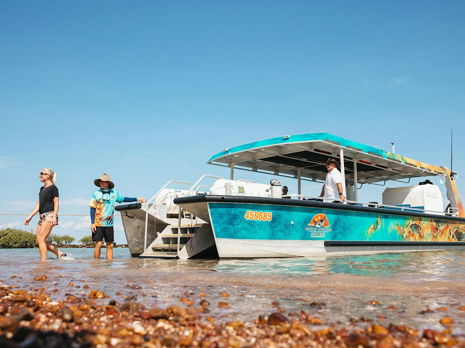 Passengers disembarking Brahminy Kite at a selcuded beach.