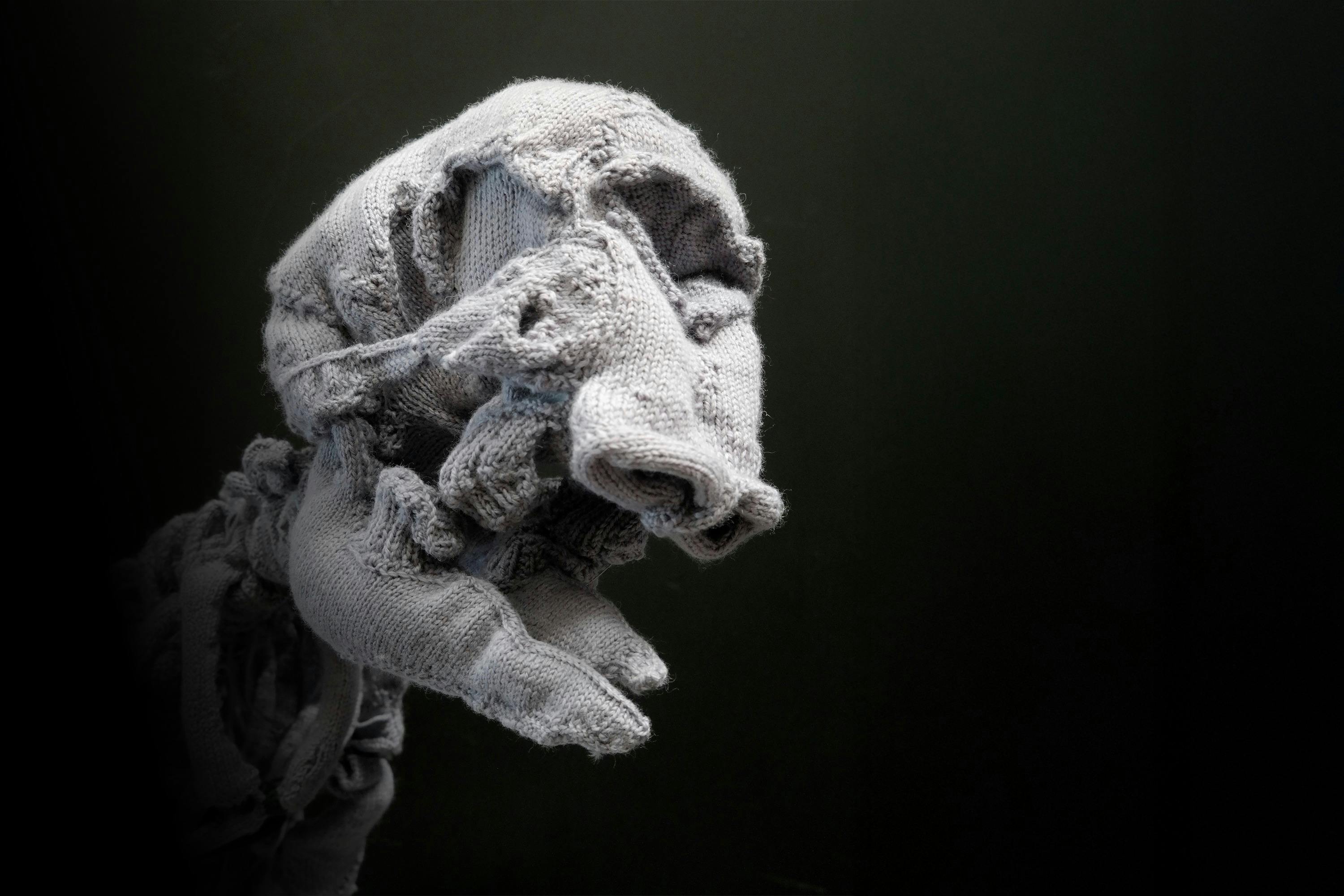 A close up of a large-scale knitted sculpture resembling an elephant skeleton.