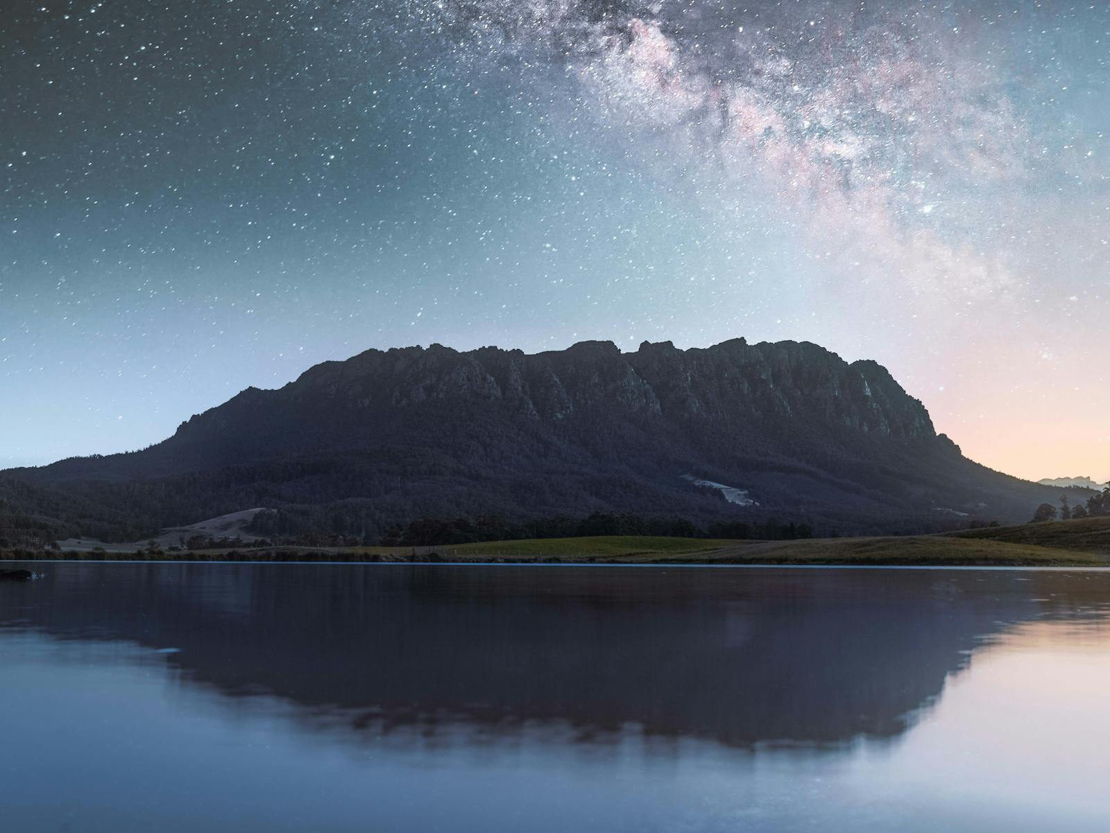 Milky Way shines of Mt Roland, both reflecting in lake waters