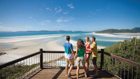 Two couples at lookout with Hill Inlet in background.