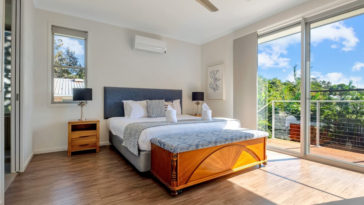 Main bedroom with king size bed, ensuite bathroom and balcony access