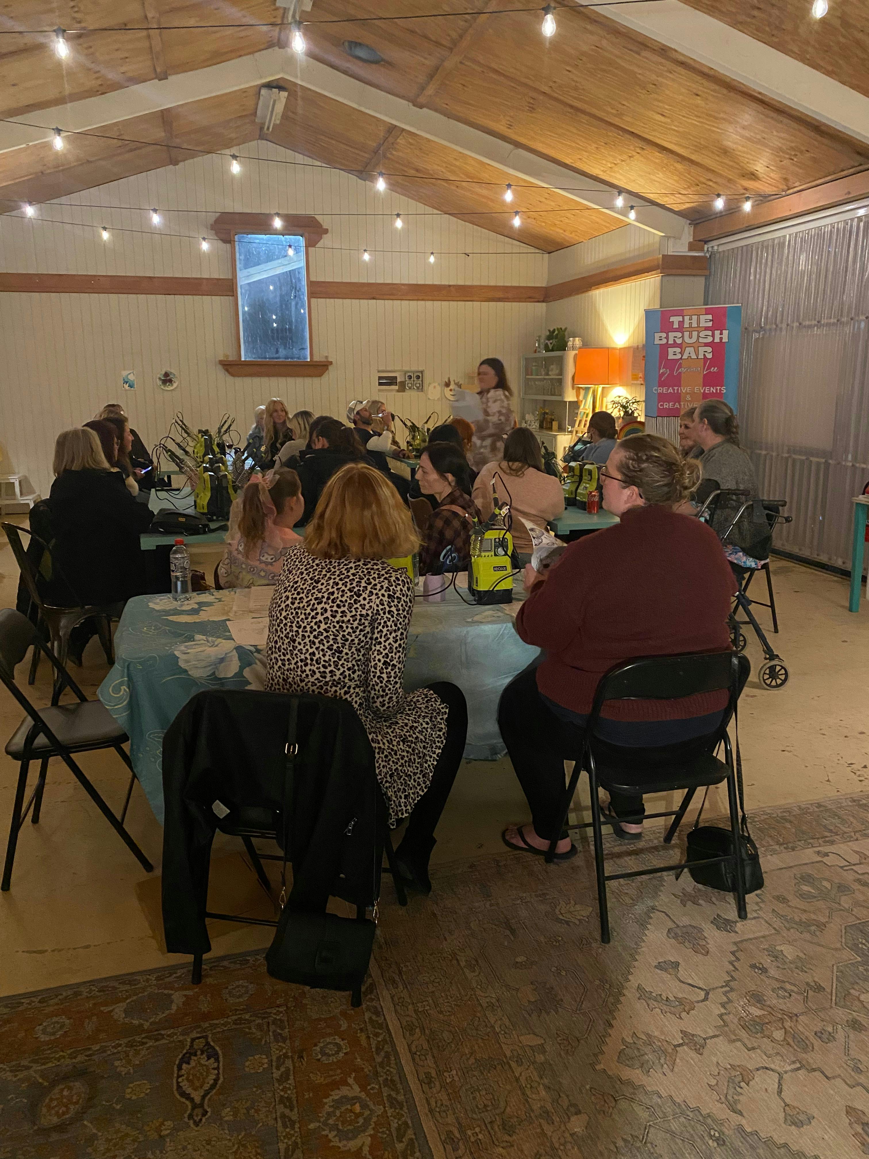 People sat at tables doing a hart burning event