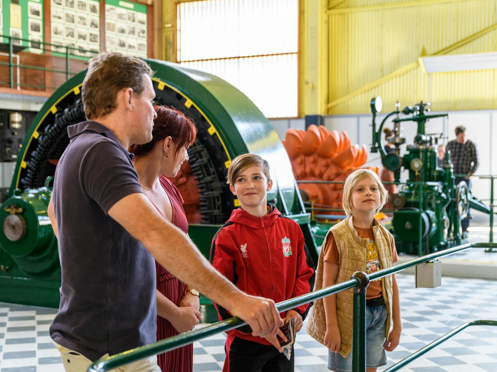 Family of two adults, 2 children in the turbine hall