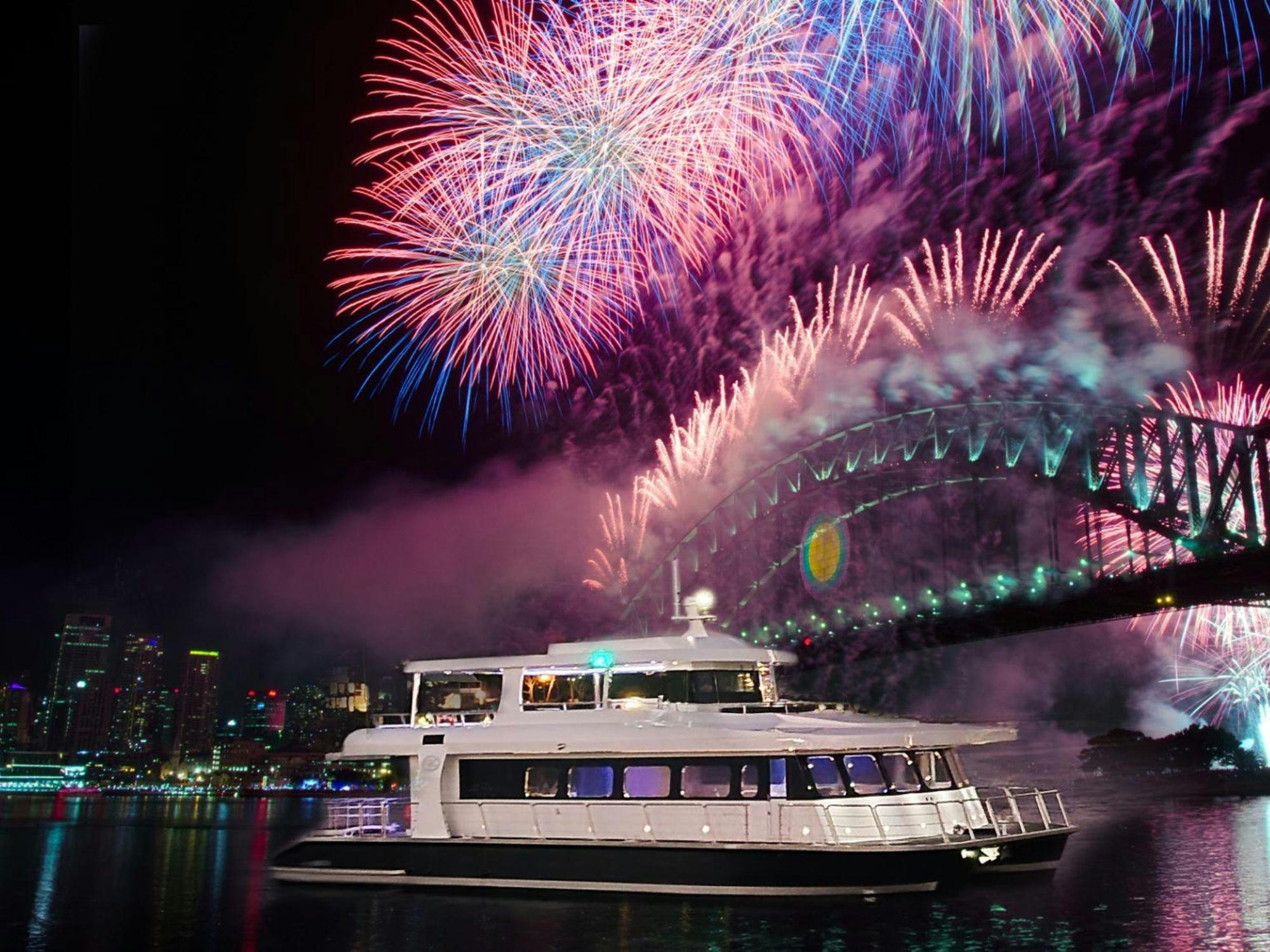 Karisma 2 event boat cruising Sydney Harbour at night with fireworks and Harbour Bridge lit up