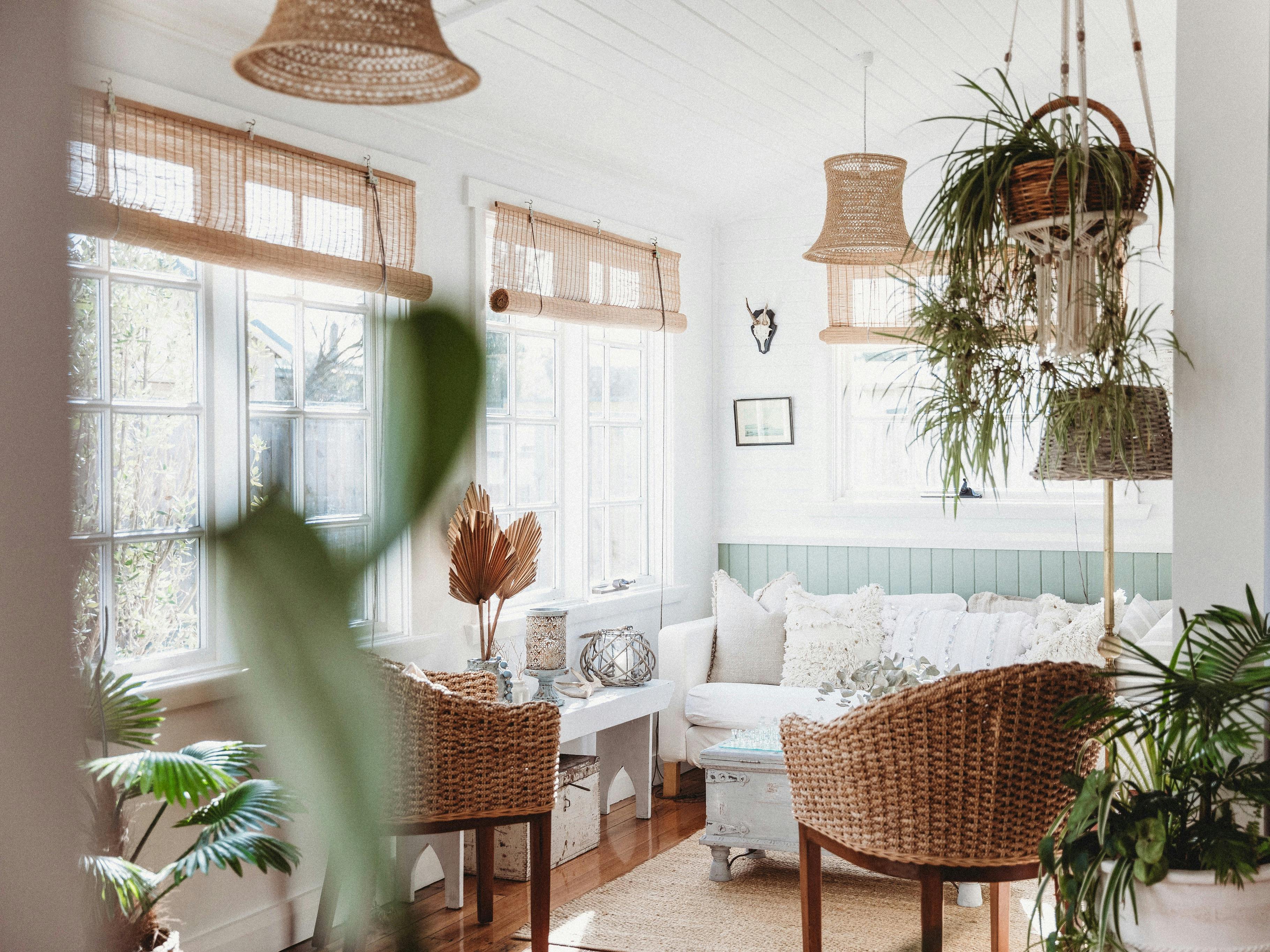 A sunroom with lots of windows and a sitting area
