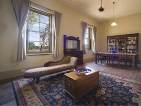 Hotel dining room with dining table, bookcase and lounge