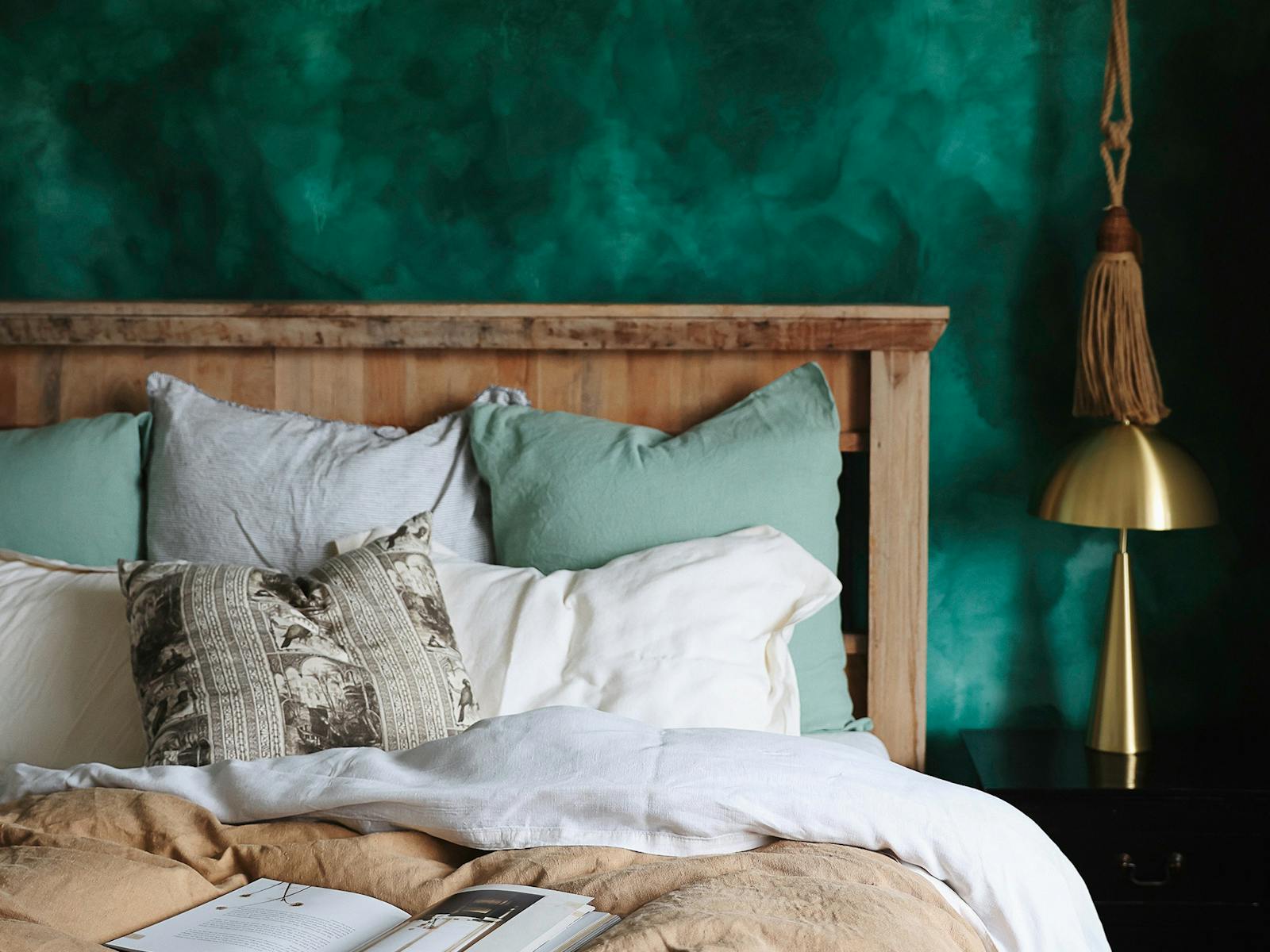 emerald green bedroom  with cosy French linen bedding