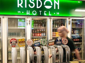 Bar at Risdon Hotel featuring beer taps and drink displays.