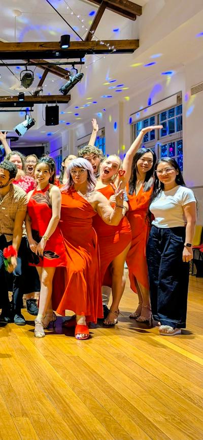 A group of social dancers dressed in for a photo following a dance workshop