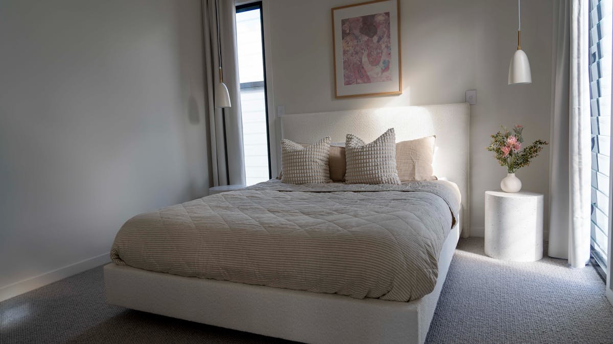 Stunning bedroom in pink and beige with art by Jai Vasicek.k