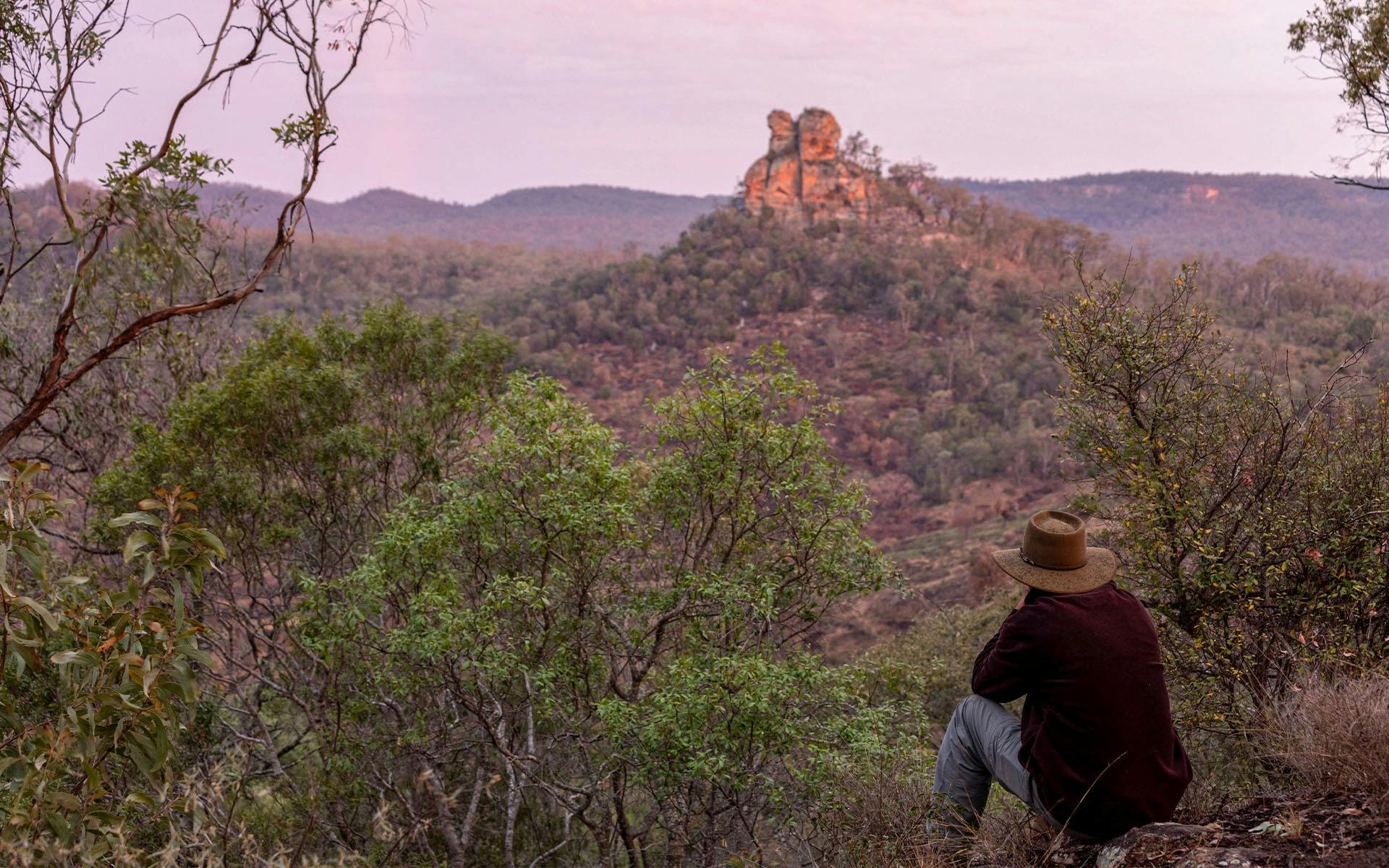A Boobook Explore holiday maker overlooking Skull Mountain  in the Carnarvon Ranges at dusk