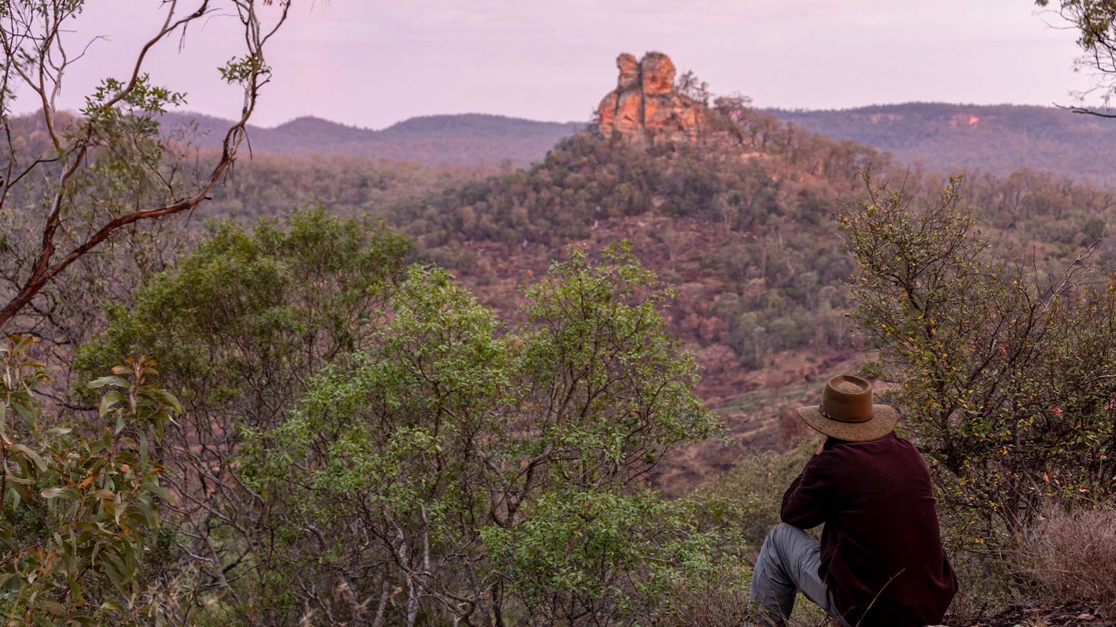 A Boobook Explore holiday maker overlooking Skull Mountain  in the Carnarvon Ranges at dusk