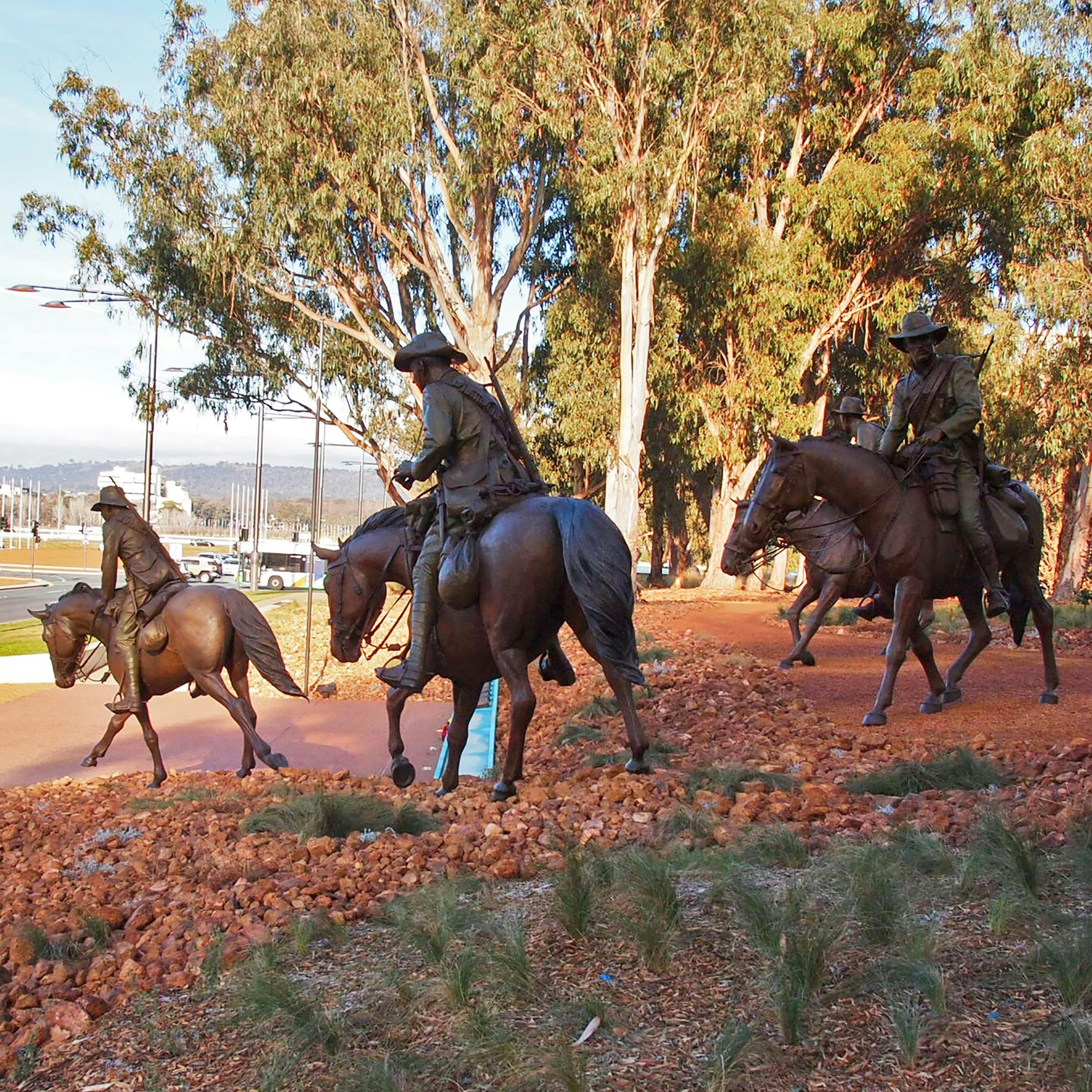 Bronze Men on horeseback emerge from the bush and cascade down the hill