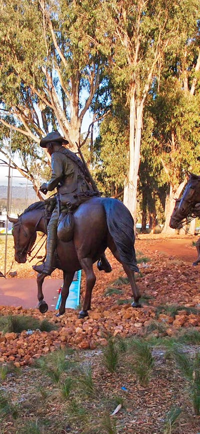 Bronze Men on horeseback emerge from the bush and cascade down the hill